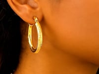 14k Yellow Gold Diamond Cut Textured Oval Hoop Earrings.